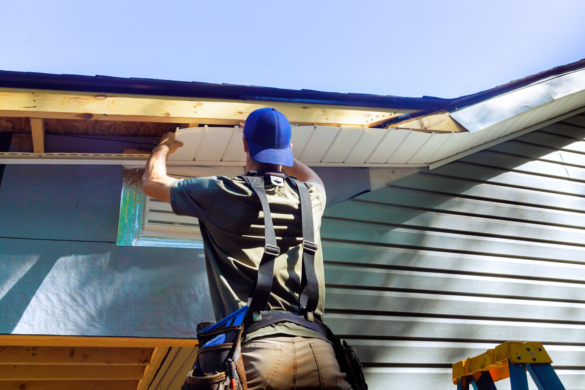 Plastic soffits mounted to roof rafters on house with a cathedral ceiling